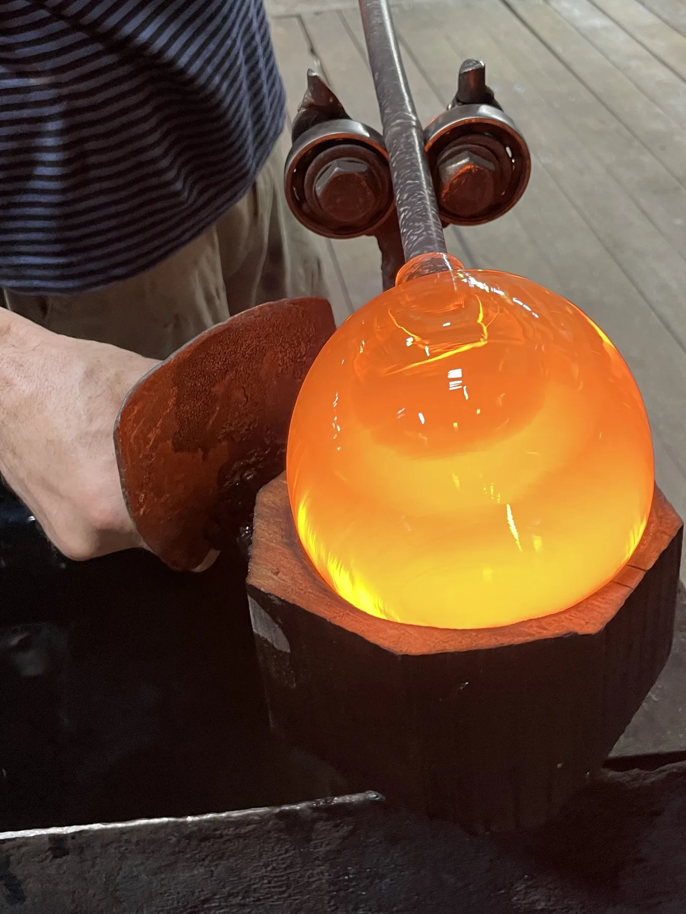 Artisan shaping mouth-blown glass